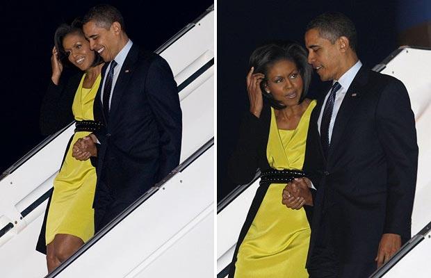 US President Barack Obama (R) and First Lady Michelle Obama walk down the steps of Air Force One after arriving at Stansted International Airport outside London